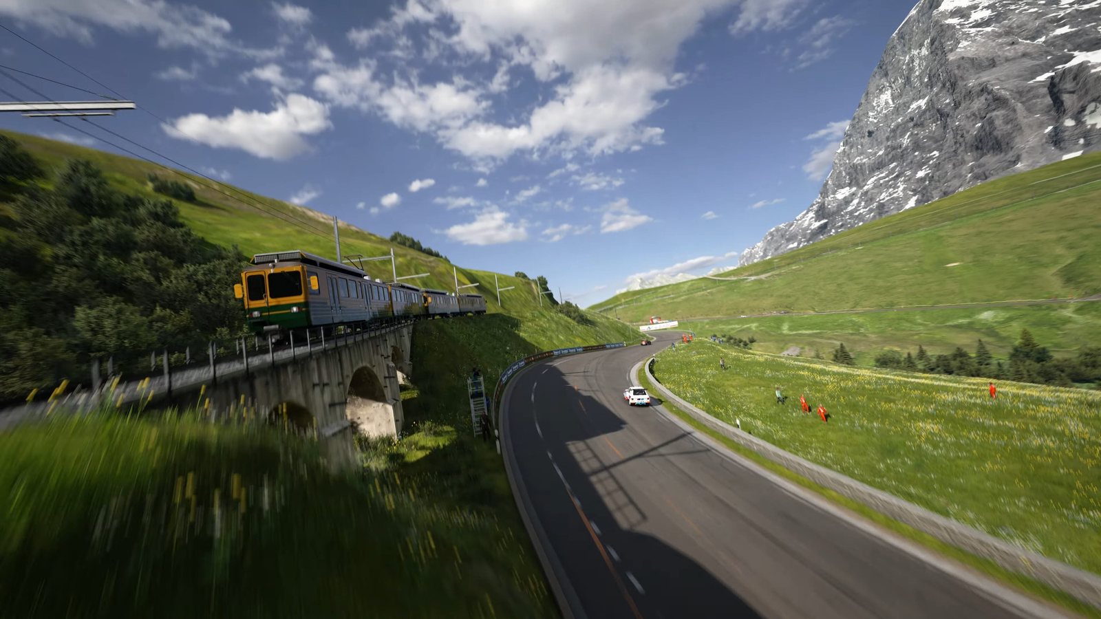 A yellow car crossing the railway bridge on the Eiger Nordwand course