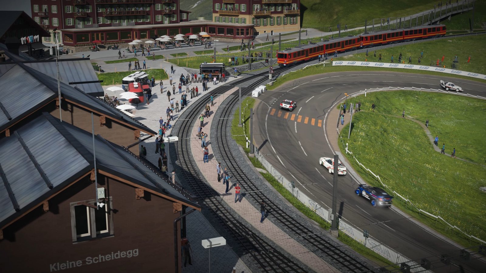 Cars cornering past the Kleine Scheidegg station on the Eiger Nordwand course