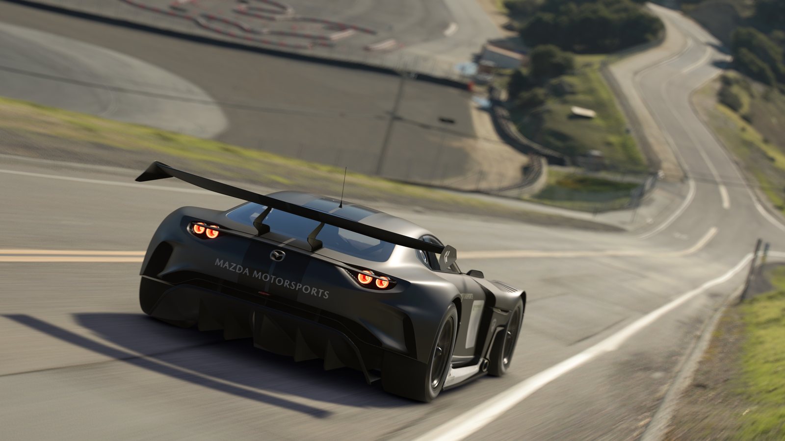 Mazda RX-Vision GT3 Concept powering along a mountain road in Gran Turismo 7