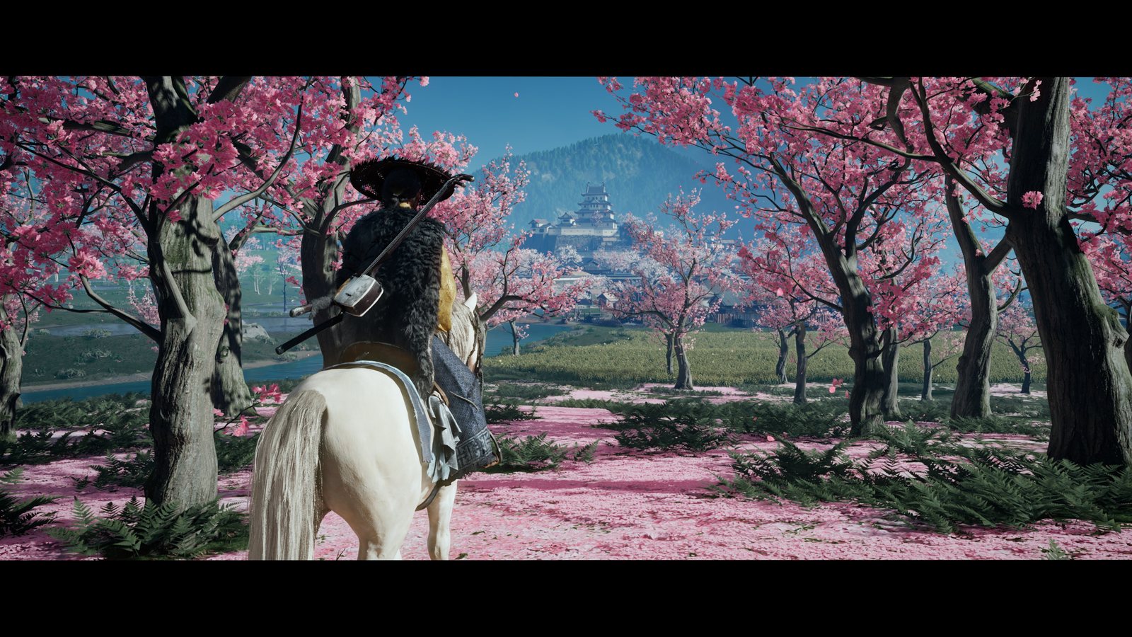 Ghost of Yōtei: Atsu on horseback under cherry blossoms